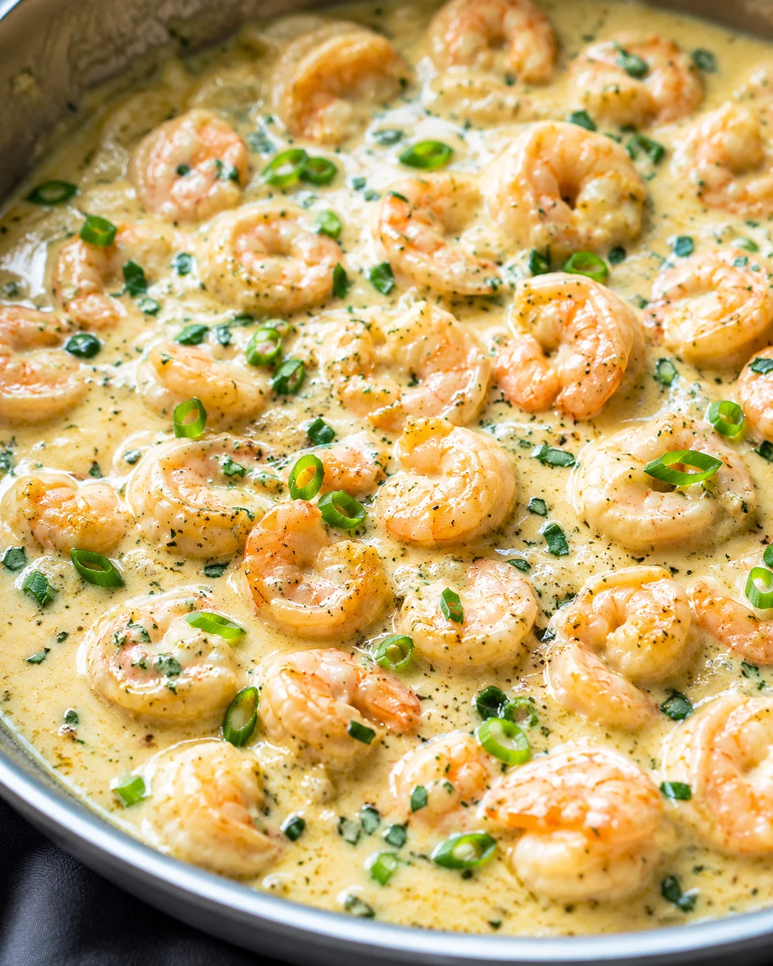 Creamy Garlic Parmesan Shrimp Dish Juicy shrimp in a rich garlic parmesan sauce garnished with green onions.