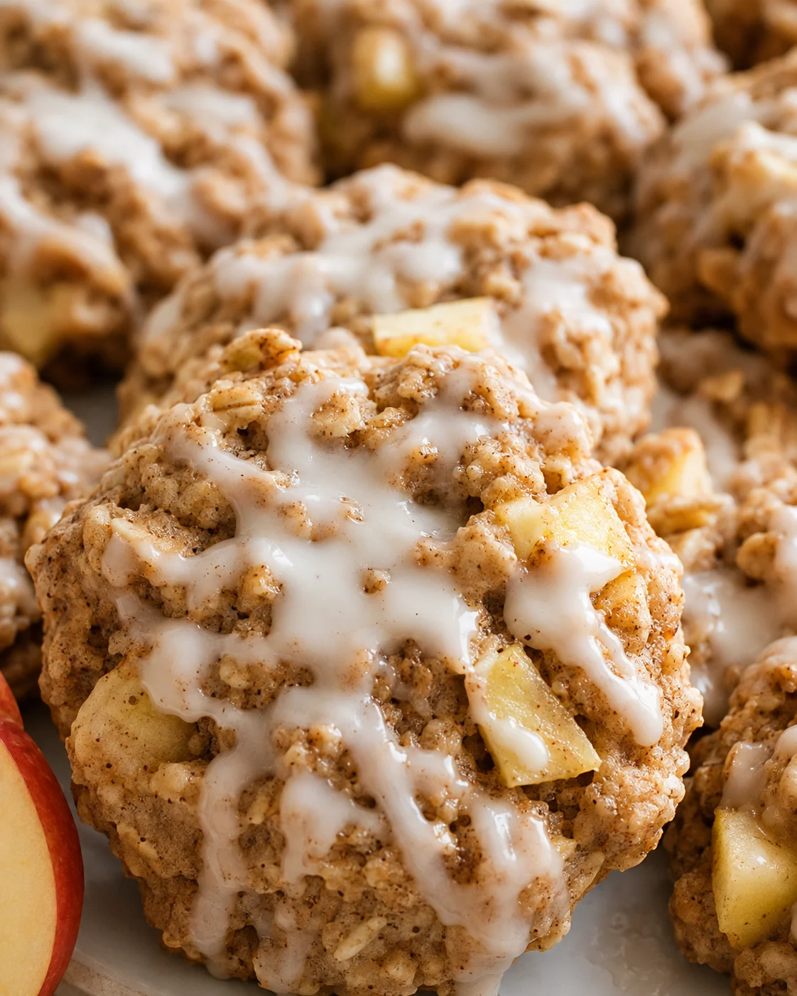 Close-up of apple cinnamon cookies drizzled with maple glaze, showcasing soft interior and crispy edges