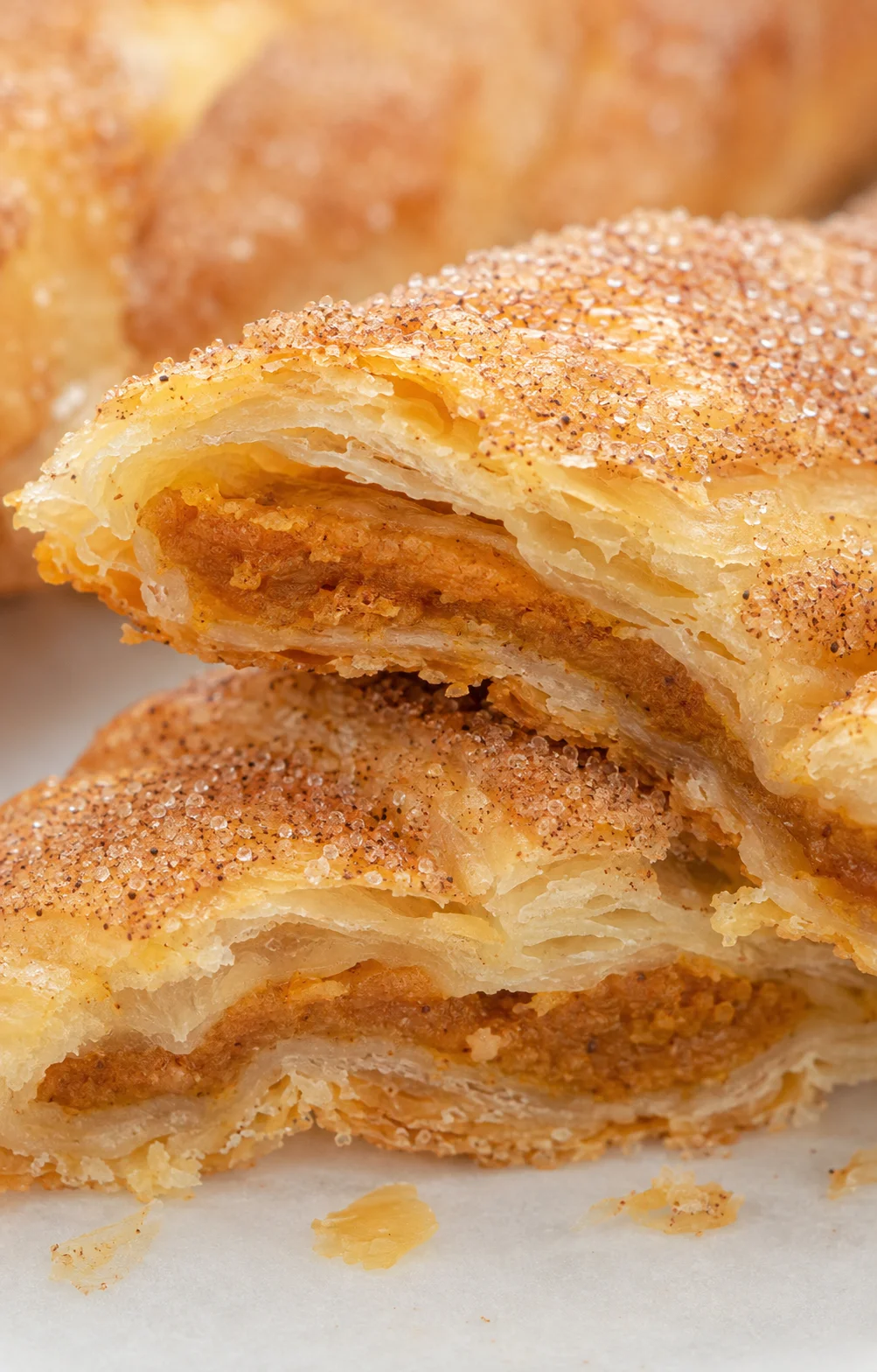 Freshly baked pumpkin pie twists featuring flaky layers and cinnamon sugar topping.